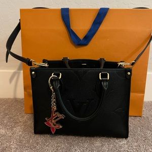 Slightly used Louis Vuitton On The Go PM tote black embossed monogram pattern